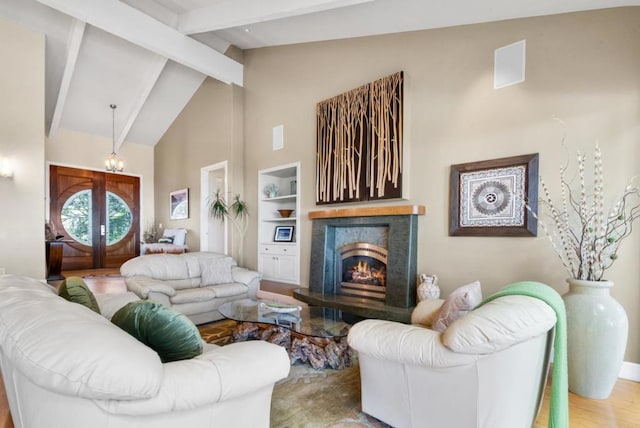 living room featuring a high end fireplace, french doors, hardwood / wood-style flooring, high vaulted ceiling, and beamed ceiling