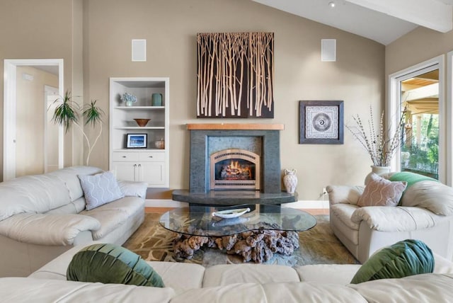 living room featuring hardwood / wood-style floors and vaulted ceiling with beams