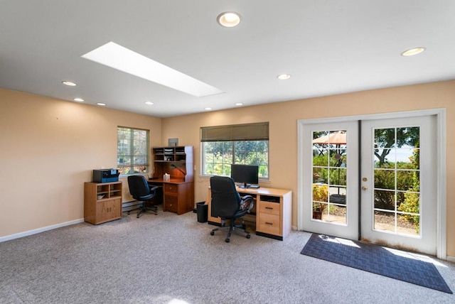 carpeted office space with french doors, a skylight, and a healthy amount of sunlight