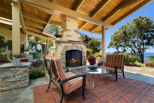 view of patio featuring an outdoor stone fireplace