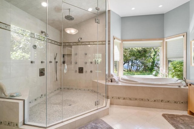 bathroom featuring tile patterned flooring and independent shower and bath