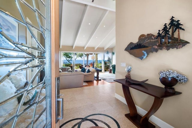 foyer entrance featuring vaulted ceiling with beams