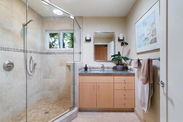 bathroom with vanity and a shower with shower door