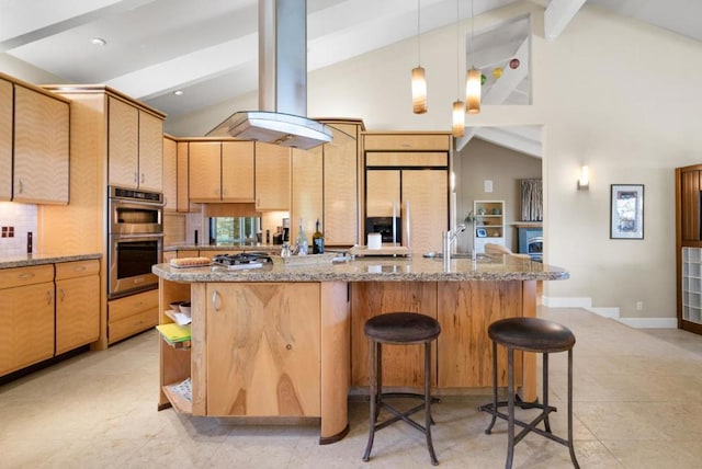 kitchen with paneled fridge, stainless steel double oven, island range hood, sink, and stone counters