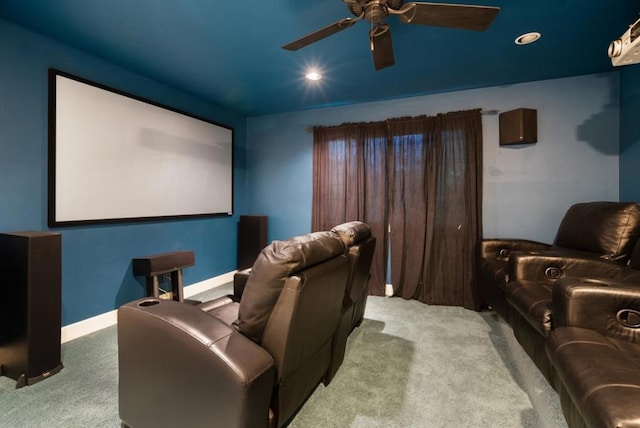 cinema with ceiling fan and light colored carpet