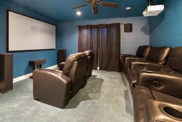 carpeted cinema room with ceiling fan