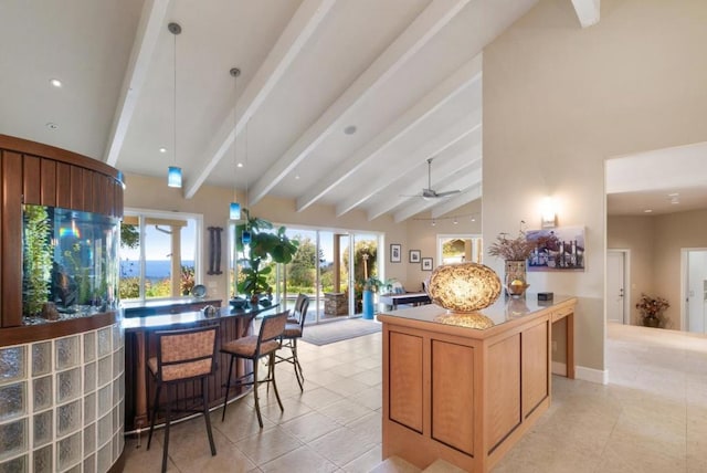 kitchen with a center island, ceiling fan, pendant lighting, vaulted ceiling with beams, and light tile patterned flooring