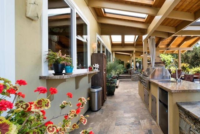 view of patio with a grill, sink, and exterior kitchen