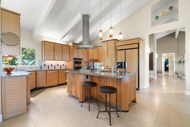 kitchen with island exhaust hood, dark stone counters, high vaulted ceiling, beamed ceiling, and hanging light fixtures