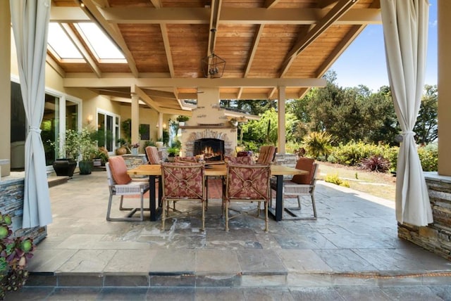 view of patio featuring an outdoor stone fireplace