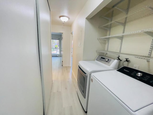 washroom with separate washer and dryer, light hardwood / wood-style floors, and baseboard heating