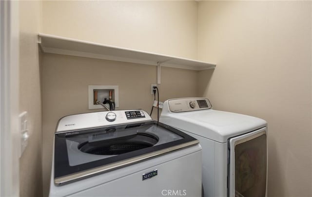 clothes washing area featuring independent washer and dryer