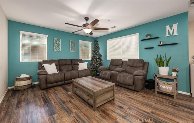 living room featuring ceiling fan and dark wood-type flooring