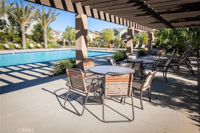 view of patio / terrace featuring a pergola and a community pool