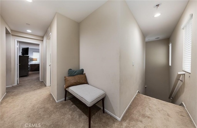 hall featuring light colored carpet