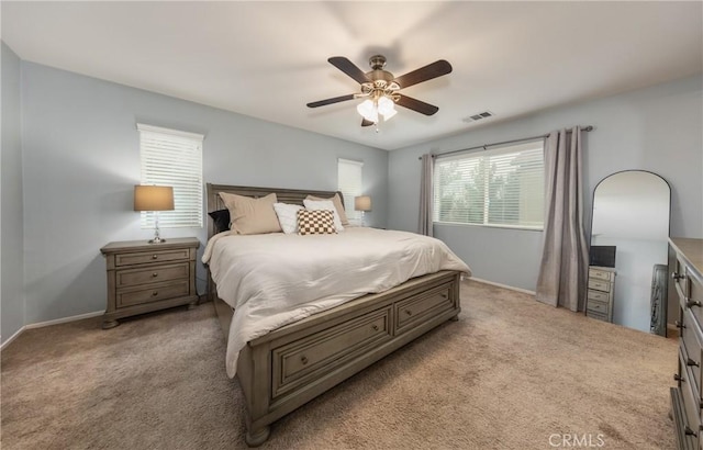 bedroom featuring ceiling fan and light carpet