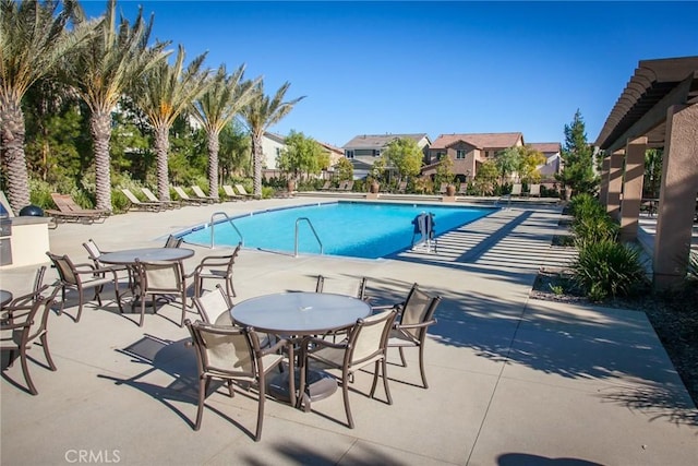 view of swimming pool with a patio area