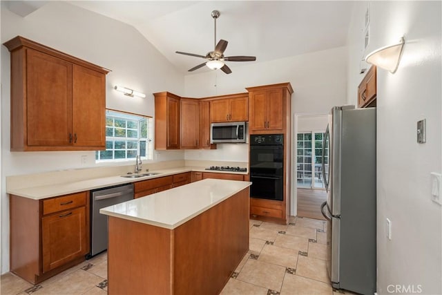 kitchen with a center island, lofted ceiling, sink, ceiling fan, and stainless steel appliances