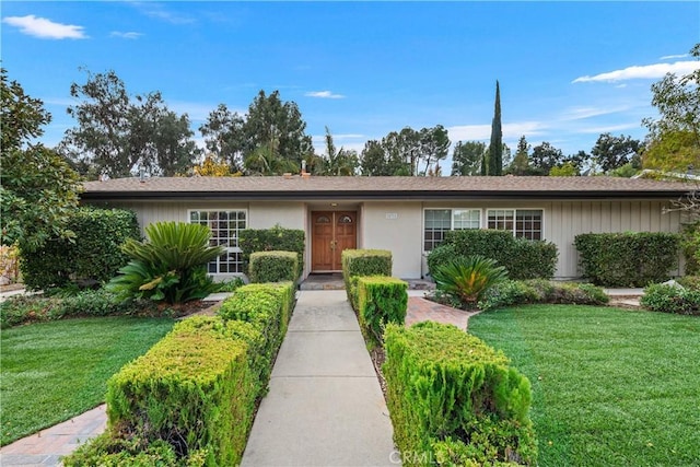 single story home with a front lawn