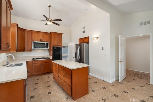 kitchen featuring stainless steel appliances, ceiling fan, sink, high vaulted ceiling, and a kitchen island