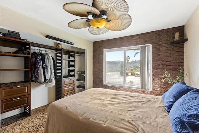 carpeted bedroom featuring brick wall and ceiling fan