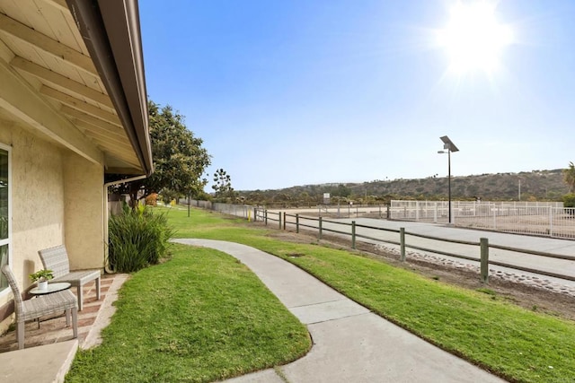 view of yard with a rural view and fence