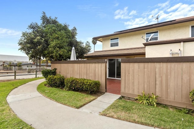 exterior space with fence and stucco siding