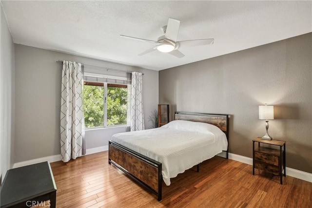 bedroom featuring hardwood / wood-style floors and ceiling fan