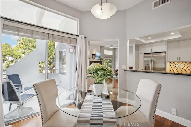 dining space featuring hardwood / wood-style flooring and ceiling fan