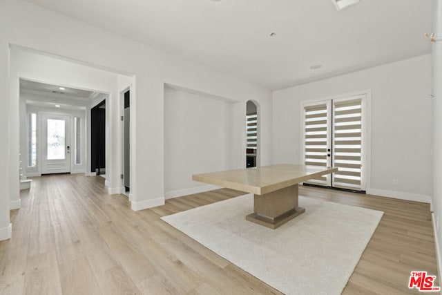 kitchen with a kitchen breakfast bar, light hardwood / wood-style flooring, and a kitchen island