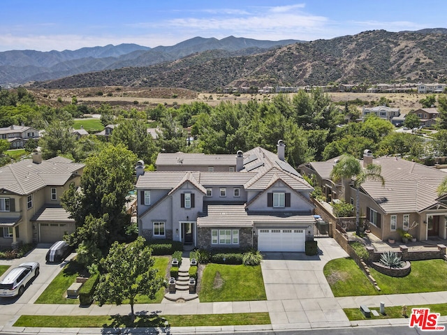 birds eye view of property with a mountain view