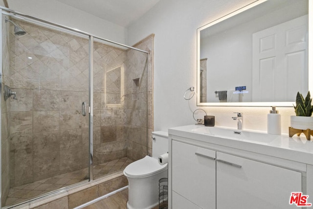 bathroom featuring walk in shower, vanity, wood-type flooring, and toilet