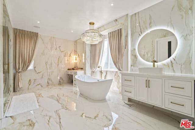 bathroom featuring a bathtub, tile walls, vanity, and an inviting chandelier