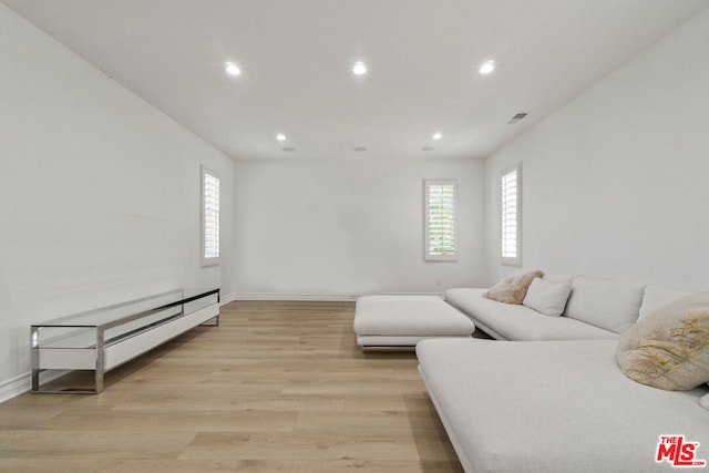 living room with light wood-type flooring and a baseboard radiator