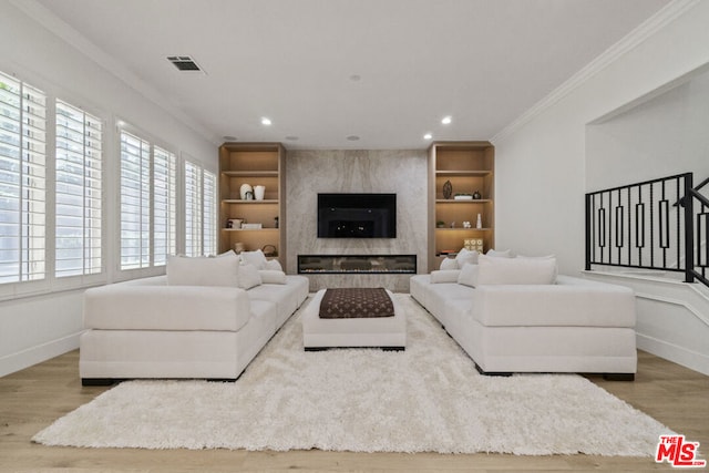 living room featuring a fireplace, hardwood / wood-style floors, and ornamental molding