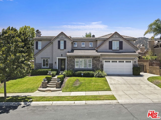 view of front of house featuring a garage and a front yard