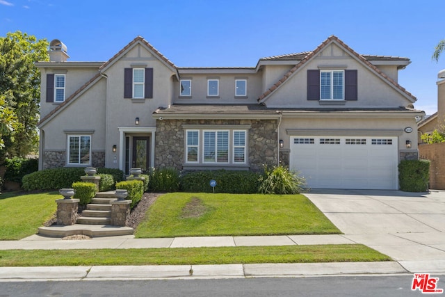 view of front of house with a front yard and a garage