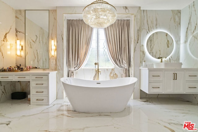 bathroom featuring a notable chandelier, a bathtub, and vanity