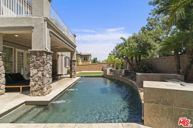 view of pool featuring pool water feature, ceiling fan, and a patio area