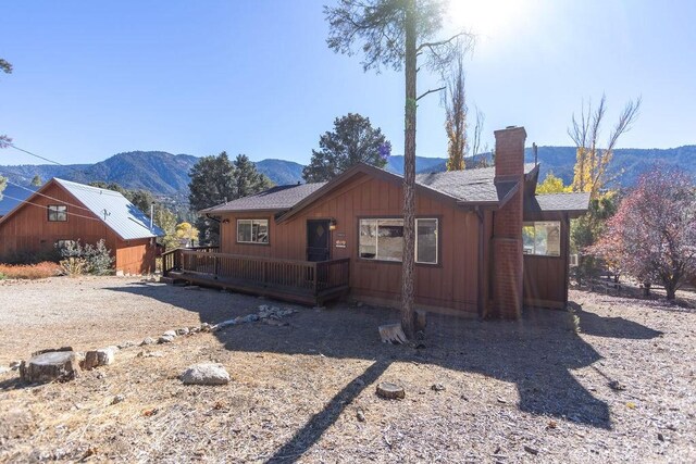 view of front of home with a deck with mountain view