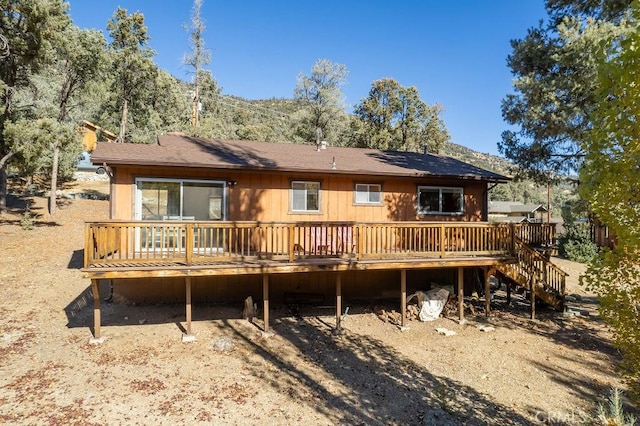 back of property featuring a wooden deck