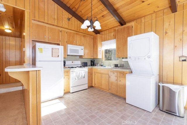 kitchen featuring pendant lighting, white appliances, stacked washer and clothes dryer, vaulted ceiling with beams, and a notable chandelier