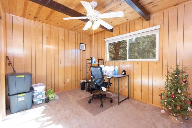 carpeted office space with beamed ceiling, ceiling fan, wooden walls, and wood ceiling