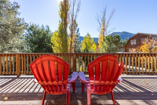 wooden deck with a mountain view