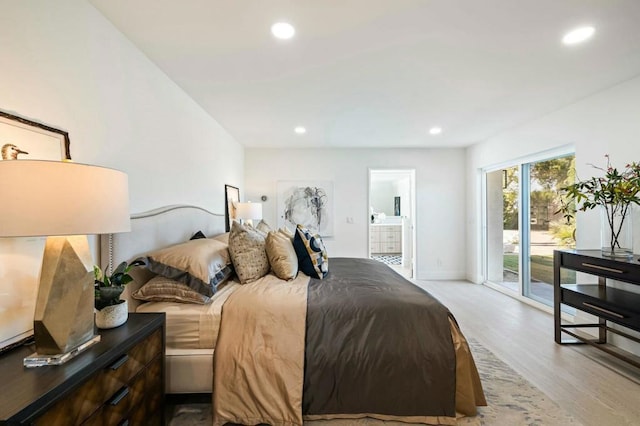 bedroom with access to exterior, connected bathroom, and light hardwood / wood-style flooring