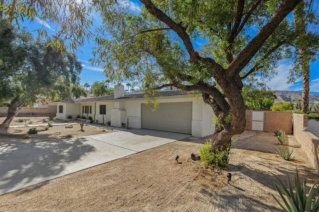 view of front of property with a mountain view and a garage