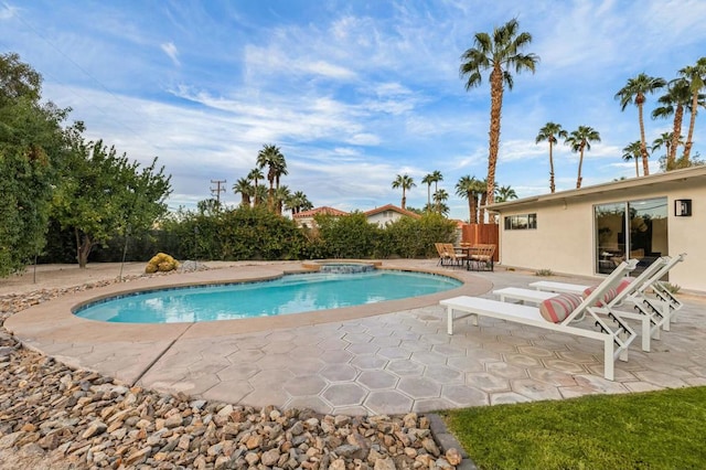 view of swimming pool featuring an in ground hot tub and a patio area