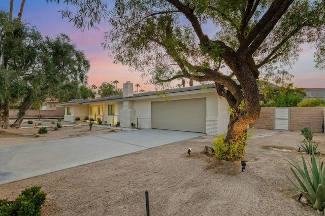 ranch-style home featuring a garage