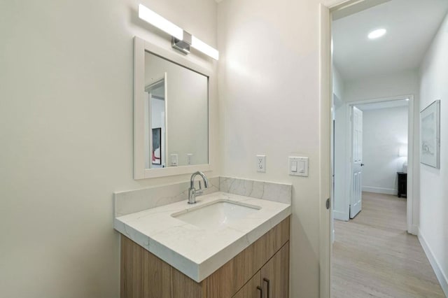 bathroom featuring wood-type flooring and vanity