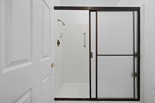 bathroom with a shower with door